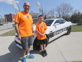 Nick Paulet runs the Winnipeg Police Half Marathon, the run will happen on Sunday, in Winipeg, he is with his son Tyler. Friday, May 01, 2015. (Chris Procaylo/Winnipeg Sun/Postmedia Network)