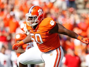 Grady Jarrett #50 of the Clemson Tigers reacts after making a tackle during the game against the North Carolina State Wolfpack at Memorial Stadium on October 4, 2014 in Clemson, South Carolina.  Tyler Smith/Getty Images/AFP