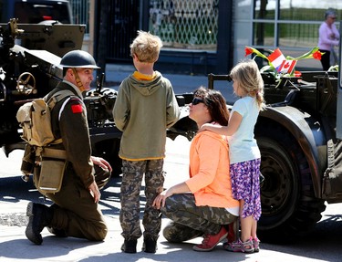 Adam and Maya Jackowski along with their mother Dorota meet  Joe McCormack, retired from the Canadian artillery during the Thank You Canada-Dutch Liberation Festival parade  on Saturday May 2, 2015. Veronica Henri/Toronto Sun/Postmedia Network