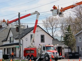 Kingston Hydro crews attach wires to new poles at the intersection of Montreal and James streets. Steph Crosier, The Whig-Standard, Postmedia Network