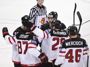 Canada's forward Nathan Mackinnon (2nd R, #29) celebrates with his teammates after scoring during the group A preliminary round ice hockey match Canada vs Latvia at the IIHF International Ice Hockey World Championship on May 1, 2015 at the O2 Arena in Prague.    AFP PHOTO / JONATHAN NACKSTRAND