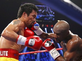Manny Pacquiao of the Philippines takes a punch from Floyd Mayweather, Jr. of the U.S. on May 1. (REUTERS)