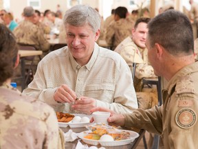 Prime Minister Stephen Harper joins Canadian Armed Forces members stationed in Kuwait for breakfast during his visit to Kuwait. (PMO/Jason Ransom/HO)