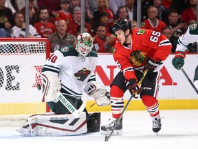 Chicago Blackhawks center Andrew Shaw (65) looks for the puck against Minnesota Wild goalie Devan Dubnyk (40) and defenseman Ryan Suter (20) during the first period in game one of the second round of the 2015 Stanley Cup Playoffs at United Center May 1, 2015. (Jerry Lai-USA TODAY Sports)