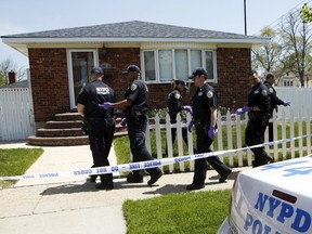 NYPD officers search house to house for the weapon used to shoot New York City plainclothes police officer Brian Moore at the Queens Village, in New York May 3, 2015. Moore, 25, was seriously injured when he was shot in the head on Saturday while attempting to question a man from his cruiser, and authorities said a suspect had been arrested and was in custody. REUTERS/Eduardo Munoz