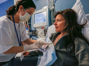 Toni Vernon is hooked up to a dialysis machine by RN Karen Bojung Ku at Sunnybrook Medical Centre in Toronto on Thursday, April 30, 2015. (Dave Thomas/Toronto Sun)