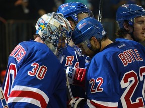 Henrik Lundqvist #30 and Dan Boyle #22 of the New York Rangers celebrate a 3-2 victory over the Washington Capitals in Game Two of the Eastern Conference Semifinals during the 2015 NHL Stanley Cup Playoffs at Madison Square Garden on May 2, 2015 in New York City.   (Bruce Bennett/Getty Images/AFP)