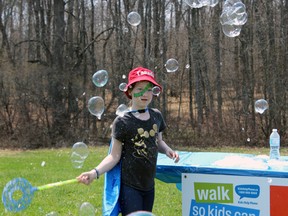Ava Maggiacomo, 8, is distracted from tear-down duties at the Walk So Kids Can Talk event in Kingston on Sunday. (Steph Crosier/The Whig-Standard)