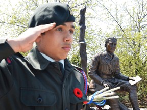 An Artillery Cadet salutes during an unveiling ceremony of a statue of Lieutenant-Colonel John McCrae at the National Artillery Memorial in Ottawa on Sunday, May 3, 2015. (Matthew Usherwood/Ottawa Sun/Postmedia Network)