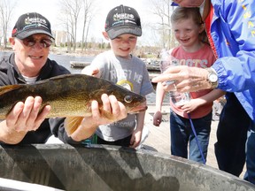 Jason Miller/The Intelligencer
Gerry Jowett show his grandchildren, Allie and Ryan his catch of the day Saturday during the Trenton Kiwanis walleye World Fishing Derby.