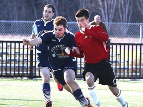 Two players chase down the ball during last week's high school soccer action from the St. Charles Notre Dame game in Sudbury, Ont. on Wednesday April 29, 2015.