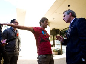 Omar Khadr's lawyer Dennis Edney, right, tries to calm an upset man outside the courthouse who was earlier removed from the courtroom for making a demonstration in Edmonton, Alta. on Monday, Sep. 23, 2013. The man is a supporter of Khadr and is upset with the pace of the justice system. Amber Bracken/Edmonton Sun/Postmedia Network