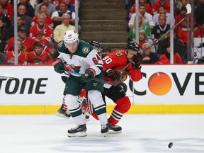 Forward Mikael Granlund (left) of the Minnesota Wild and Blackhawks centre Antoine Vermette go after the puck during the first period of Game 2 of their Western Conference semifinal matchup on Sunday night in Chicago. (USA Today Sports)