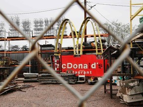 A McDonald's sign sits in a scrap yard in Phoenix, Arizona January 31, 2015. McDonald's Corp franchisees have an urgent order for the fast-food giant's new CEO Steve Easterbrook - get back-to-basics. In interviews, franchisees say they hope the new chief will shrink its huge menu to concentrate on burgers and fries. REUTERS/Brian Snyder