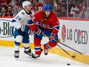 Brandon Prust #8 of the Montreal Canadiens tries to move the puck past Ryan Callahan #24 of the Tampa Bay Lightning in Game Two of the Eastern Conference Semifinals during the 2015 NHL Stanley Cup Playoffs at the Bell Centre on May 3, 2015 in Montreal, Quebec, Canada. (Minas Panagiotakis/Getty Images/AFP)