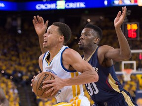Golden State Warriors guard Stephen Curry (30, left) drives to the basket against New Orleans Pelicans guard Norris Cole (30, right) during the third quarter in game two of the first round of the NBA Playoffs at Oracle Arena. (Kyle Terada-USA TODAY Sports)