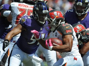 Running back Doug Martin of the Tampa Bay Buccaneers runs into the defense of the Baltimore Ravens. (Cliff McBride/AFP)