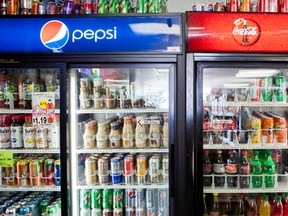 Cans of soda are displayed in a case at Kwik Stops Liquor in San Diego, California February 13, 2014.  REUTERS/Sam Hodgson