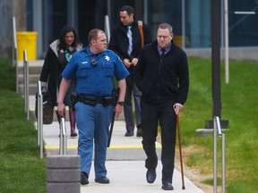 Josh Nowlan, right, leaves Arapahoe County District Court in Centennial, Colorado April 27, 2015. Nowlan was shot in the left calf and right arm during a mass shooting in Aurora on July 20, 2012. REUTERS/Evan Semon