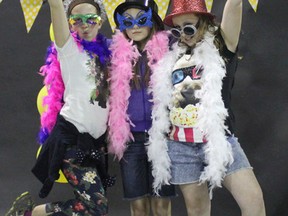 Elianne Kreuger, Shayna Hunking and Hailey Govier dress up and take advantage of the photo booth. (Laura Broadley Clinton News Record)