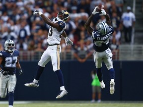 Morris Claiborne of the Dallas Cowboys intercepts a pass intended for Brian Quick of the St. Louis Rams.  (Dilip Vishwanat/AFP)