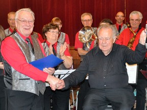 Clare French (left) congratulates Harry Adams on his retirement from the Mitchell Legion Band after 76-years, during the band’s spring concert last Tuesday, April 28. Inset, Harry cracks his trademark smile. ANDY BADER/MITCHELL ADVOCATE