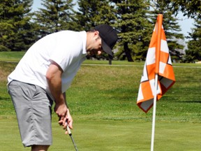 Joe McCreight prepares to line up a putt towards the new 15-inch holes during the 1st annual Mitchell Golf & Country Club’s two-man scramble tournament last Saturday, May 2. The unique, larger holes are a way to try and attract new golfers. ANDY BADER/MITCHELL ADVOCATE