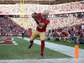 Bruce Miller of the San Francisco 49ers completes a pass for a touchdown.  (Don Feria/AFP)