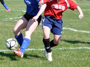 Nicole Gettler (left) of the Mitchell District High School (MDHS) senior girls soccer team battles for possession of the ball with this Central Huron opponent during Huron-Perth soccer action last Tuesday, April 28 at Parmalat fields in Mitchell. ANDY BADER/MITCHELL ADVOCATE