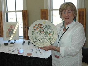 Paulette Robertson with one of her clay creations Saturday at the Station Arts Centre in Tillsonburg during the 8th Annual Oxford Studio Tour. (CHRIS ABBOTT/TILLSONBURG NEWS)