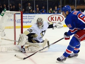 Marc-Andre Fleury of the Pittsburgh Penguins makes a save on Rick Nash of the New York Rangers in Game One of the Eastern Conference Quarterfinals. (Bruce Bennett/AFP)