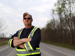 Hastings County Warden Rick Phillips stands on Shannonville Road in Tyendinaga Township, where he is also the reeve, Monday. He said Ontario lacks a clear, sustainable plan for helping rural municipalities and recent provincial decisions on doctor recruitment and liability are hurting small-town Ontario.