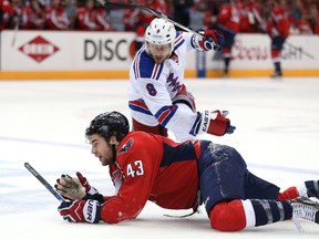 Capitals’ Tom Wilson is tripped up by New York Rangers’ Kevin Klein during Game 3 on Monday night in Washington, D.C.  (AFP/PHOTO)