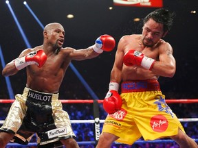 Floyd Mayweather Jr. (left) lands a punch to the face of Manny Pacquiao in the 11th round during their title fight in Las Vegas May 2, 2015. (REUTERS/Steve Marcus)