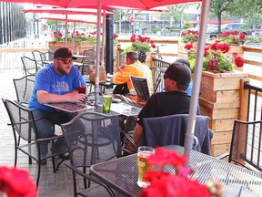 Gino Donato/The Sudbury Star 
Customers enjoy some food and drinks at the Peddlers Pub patio on Cedar Street last summer.