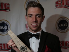 Ross Proudfoot holds up his award for male university athlete of the year at the 23rd annual BLG Awards at the Martha Cohen Theatre in Calgary on Monday.