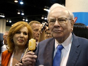 Berkshire Hathaway CEO Warren Buffett enjoys a Dairy Queen ice cream bar prior to the Berkshire annual meeting in Omaha, Nebraska, United States, in this file photo taken May 2, 2015. Buffett has agreed this year to again lunch with the winner of an auction to benefit a San Francisco charity. (REUTERS/Rick Wilking/Files)