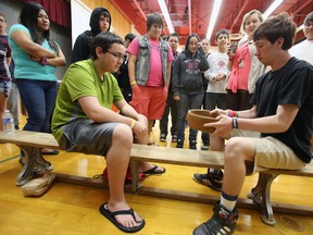 JEROME LESSARD/THE INTELLIGENCER
Grade 9-12 students at Moira Secondary School in Belleville, and some who are visiting from Nunavut, Yellowkinfe, Inuvik, and Kingston, participate in a Planting Festival at the Victoria Avenue school, where students were invited to share local Mohawk culture, Tuesday.