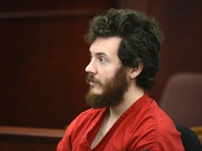 Accused Aurora theater shooting suspect James Holmes listens at his arraignment in Centennial, Colorado in this March 12, 2013 file photo. While the details emerging in the Colorado movie theater massacre trial have been almost too much to bear for many, glimmers of the human spirit and resilience have also shone through at times in the windowless, low-ceiling courtroom.  REUTERS/R.J. Sangosti/Pool/Files