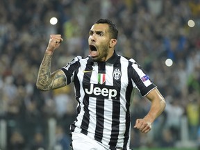 Juventus' forward from Argentina Carlos Tevez celebrates after scoring a penalty kick during the UEFA Champions League semi-final first leg football match Juventus vs Real Madrid on May 5, 2015 at the Juventus stadium in Turin. (AFP PHOTO / OLIVIER MORIN)