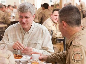 Prime Minister Stephen Harper joins Canadian Armed Forces members stationed in Kuwait for breakfast during his visit. (PMO/Jason Ransom/HO)