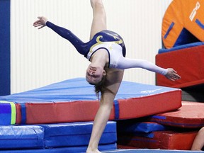 Christine Cousineau of College Notre Dametakes part in the floors competition at OFSAA at the Gymzone in Sudbury, Ont. on Tuesday afternoon.