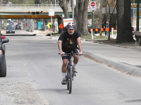A cyclist rides down Assiniboine Avenue. (FILE PHOTO)