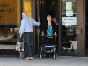 Kirsten Cote, 43, leaves the courthouse on Tuesday, May 5, 2015 after testifying at the trial of her husband, Christopher Hoare, who's accused of trying to kill her with a baseball bat. Hoare, 45, pleaded not guilty to attempted murder but guilty to assault with a weapon in the April 2, 2014 attack. (TONY SPEARS/Ottawa Sun/Postmedia Network)