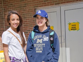 First time voters Trinity Ratzloff (left), 18, and Adecia Fox (right), 18, stand outside the polling station in Pincher Creek, Alta. after casting their ballots in the provincial election on May 5, 2015. John Stoesser photo/Pincher Creek Echo.