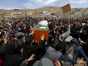 Afghan women's rights activists carry the coffin of Farkhunda, an Afghan woman who was beaten to death and set alight on fire on Thursday, during her burial ceremony in Kabul March 22, 2015. REUTERS/Mohammad Ismail