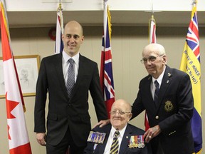 MP Ben Lobb presented Clinton residents Douglas Andrews (sitting) and Terrance Maguire with a tribute lapel pin and certificate at the Clinton branch of the Royal Canadian Legion last Saturday. (Laura Broadley Clinton News Record)