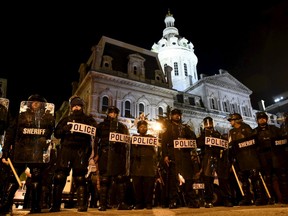 Baltimore residents cautiously celebrated news on Friday that six police officers involved in the arrest of Freddie Gray face criminal charges, a marked contrast to recent rioting over fraught relations between police and the African-American community. A group of protesters challenged the city's curfew near the City Hall. REUTERS/Sait Serkan Gurbuz