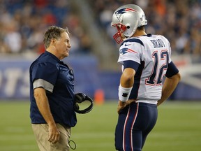 New England Patriots head coach Bill Belichick talks with quarterback Tom Brady during a break in the action as they take on the Carolina Panthers in the first half at Gillette Stadium on Aug. 22, 2014. (David Butler II/USA TODAY Sports)
