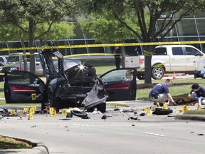 Local police and FBI investigators collect evidence, including a rifle, where two gunmen were shot dead after their bodies were removed in Garland, Texas May 4, 2015. Texas police shot dead two gunmen who opened fire on Sunday outside an exhibit of caricatures of the Prophet Mohammad that was organized by a group described as anti-Islamic and billed as a free-speech event. REUTERS/Laura Buckman